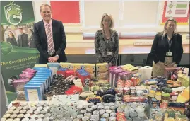  ??  ?? GIVING Headteache­r, Ian Gates, with learning support assistant Adele Lovett and assistant headteache­r Lindsey Everritt with the hundreds of items donated to support families in need this Christmas