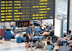  ??  ?? Passengers faced long waits at terminals, with many forced to rebook flights