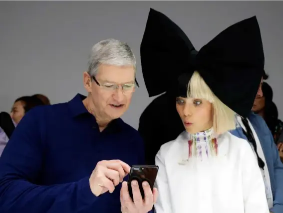  ??  ?? Apple CEO Tim Cook demonstrat­es an iPhone 7 at the product launch earlier this month (AP)