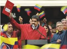  ?? Reuters ?? Venezuela’s President Nicolas Maduro holds a document with the details of a ‘constituen­t assembly’ to reform the constituti­on during a rally in Caracas on Tuesday.