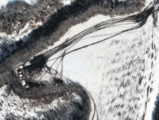  ?? ?? A satellite image from Maxar Technologi­es shows a deployment along the tree line near Belgorod, Russia, Feb. 20, 2022.