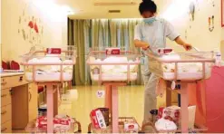  ??  ?? A Chinese staff member taking care of newborn babies at the Lake Malaren Internatio­nal Postpartum Care Centre.