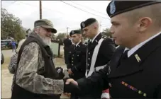  ?? AP PHOTO/ERIC GAY ?? Veteran and Sutherland Springs First Baptist Church member Ted Montgomery (left), greets members of the St. Mary’s ROTC following a Veterans Day event, Saturday in Sutherland Springs, Texas. A man opened fire inside the church in the small South Texas...