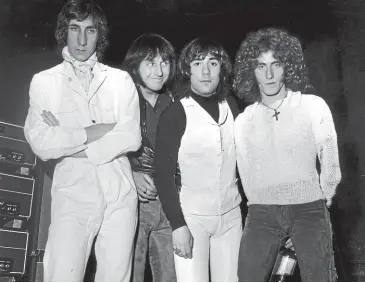  ?? GETTY IMAGES. ?? Roger Daltrey, right, with his ‘‘enemies’ from the British rock group The Who, from left to right; Pete Townshend, John Entwistle and Keith Moon shortly before going on stage at the London Coliseum in February 1969.