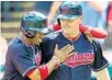  ?? JASON MILLER/GETTY IMAGES ?? Central Florida’s Francisco Lindor, left, celebrates with Jay Bruce after Cleveland breaks the record.