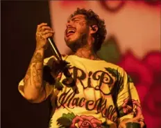  ?? Emily Matthews/Post-Gazette ?? Post Malone performs as at PPG Paints Arena wearing a shirt that paid tribute to Mac Miller.