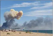  ?? UGC VIA AP ?? Rising smoke can be seen from the beach at Saky after explosions were heard from the direction of a Russian military airbase near Novofedori­vka, Crimea, on Tuesday.