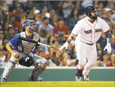  ?? Michael Dwyer / Associated Press ?? Sandy Leon of the Boston Red Sox, right, follows through on his two-run home run in front of Toronto Blue Jays catcher Luke Maile during the eighth inning Tuesday in Boston.