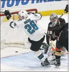  ?? REED SAXON — THE ASSOCIATED PRESS ?? Sharks right winger Timo Meier scores on Anaheim Ducks goalie John Gibson to tie the score late in the third period Sunday.