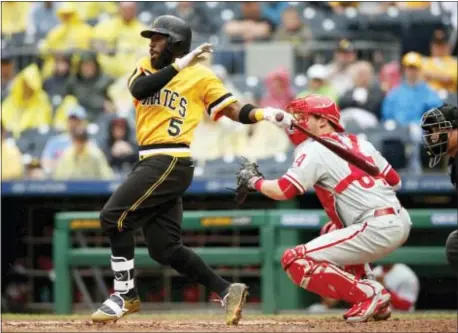  ?? JARED WICKERHAM — THE ASSOCIATED PRESS ?? Pirates third baseman Josh Harrison (5) hits a single in the sixth inning against the Phillies Sunday in Pittsburgh.