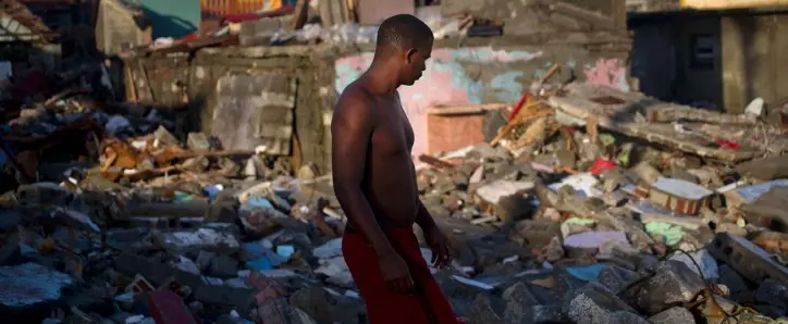  ??  ?? DEVASTATIO­N: A man walks through the ruins of homes destroyed by Hurricane Matthew looking for personal belongings to salvage, in Baracoa, Cuba. Matthew hit Cuba’s eastern tip last Tuesday, damaging hundreds of homes but there were no reports of...