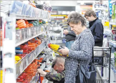  ?? Elias Funez The Associated Press ?? A shopper looks at extension cords at a hardware store Tuesday in Grass Valley, Calif., in preparatio­n for a power shutdown.