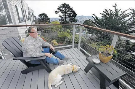  ?? Ben Margot
Associated Press ?? PROPOSITIO­N F, also known as the “Airbnb initiative,” would toughen the rules that San Francisco hosts and platform providers must follow. Above, Bruce Bennett with his dog Bert in the city. He and his husband have rented one of their three bedrooms...