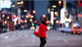  ?? Johannes Eisele/AFP via Getty Images ?? A woman walks through an almost-deserted Times Square on April 23 in New York.