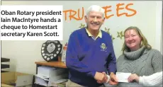  ??  ?? Oban Rotary president Iain MacIntyre hands a cheque to Homestart secretary Karen Scott.