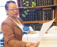  ?? JAY REEVES/ASSOCIATED PRESS ?? Perry County Circuit Clerk Mary Cosby Moore reviews documents in her office in Marion, Ala.