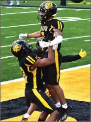  ?? (Pine Bluff Commercial/I.C. Murrell) ?? UAPB wide receiver Tyrin Ralph is hoisted in the air after hauling in a 31-yard touchdown pass against Prairie View A&M on Saturday at Golden Lion Stadium in Pine Bluff.