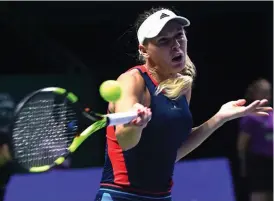  ?? — AFP ?? Denmark’s Caroline Wozniacki en route to her 7- 5, 3- 6, 6- 2 win over Petra Kvitova of the Czech Republic in their WTA Finals match in Singapore on Tuesday