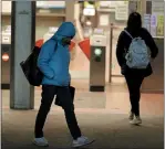  ?? ANDA CHU STAFF PHOTOGRAPH­ER ?? Bundled up against the cold, commuters make their way through the Fremont BART Station in Fremont on Wednesday. Unusually cold, dry weather is hitting the Bay Area over the next few days, according to the National Weather Service.