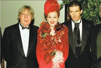  ?? Fred Prouser / Reuters 1996 ?? Alan Parker (left) poses with “Evita” stars Madonna and Antonio Banderas at the world premiere of the director’s movie in 1996 at the Shrine Auditorium in Los Angeles.