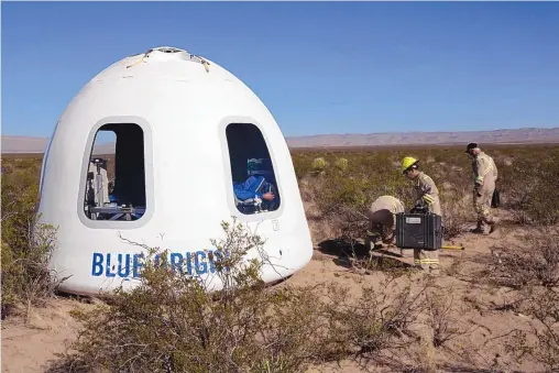  ?? BLUE ORIGIN VIA ASSOCIATED PRESS ?? The New Shepard Crew Capsule 2.0 is examined after landing in West Texas during a test in 2017. Named after the first American in space, Alan Shepard, the spacecraft made a 10-minute suborbital flight. An instrument­ed test dummy was aboard, named Mannequin Skywalker.