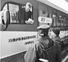  ??  ?? A train conductor speaks with local station workers at the main railway station in Belgrade. — AFP photo