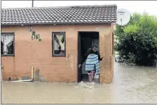 ??  ?? A resident Lerato Mokoto gets out of her flooded RDP house in Extension 38 Mahikeng.