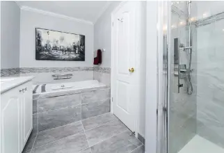  ?? MELISSA LEROUX PHOTOGRAPH­Y ?? The Barrhaven clients said they appreciate­d Westend Bath and Kitchen designer Rebecca Neale’s profession­al design sense. The flow created by the tasteful mid-level tile accent is just one of the details they love about their new ensuite. Below: An old...