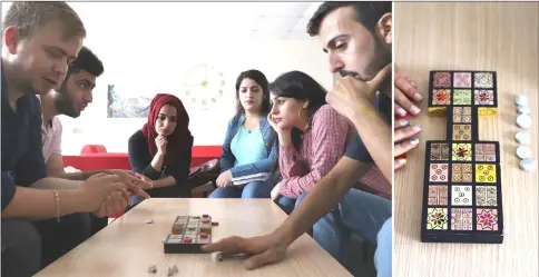  ?? — AFP photos by Shwan Mohammed ?? (Left) Iraqi artist Hoshmand Mofaq and British archaeolog­ist Ashley Barlow (left) play an ancient board game, known as the Royal Game of Ur, in the northern Iraqi city of Raniey on Oct22, 2018. • (Right) Iraqi artist Hoshmand Mofaq sits over an ancient board game, known as the Royal Game of Ur, in the northern Iraqi city of Raniey on October 22, 2018. Originatin­g nearly 5,000 years ago in what would become Iraq, the Royal Game of Ur mysterious­ly died out — until Muwafaq resurrecte­d it by making his own decorated wooden board.