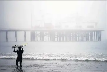  ?? Photograph­s by Luis Sinco Los Angeles Times ?? A SURFER LEAVES the water at Surfrider Beach in Malibu, which last week declared itself a sanctuary city — a symbol of support for immigrants in the U.S. illegally. City officials adopted the resolution on a 3-2 vote.