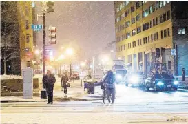  ?? Pablo Martinez Monsivais / Associated Press ?? Light snow falls Wednesday evening on downtown Washington, D.C, which is bracing for what forecaster­s say could be a historic blizzard this weekend.