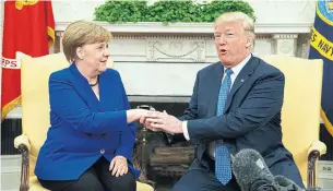  ?? EVAN VUCCI/THE ASSOCIATED PRESS ?? U.S. President Donald Trump and German Chancellor Angela Merkel meet briefly on Friday.