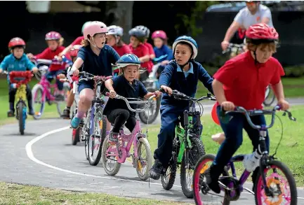  ?? PHOTO: MURRAY WILSON/FAIRFAX NZ ?? Terrace End School students celebrate the opening of their Bikes in Schools tracks.