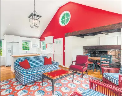  ?? Contribute­d photo ?? The one-bedroom guest cottage at 21 Clapboard Ridge Road, part of the 6.13-acre mid-country compound, has a pop of color courtesy of a red accent wall.