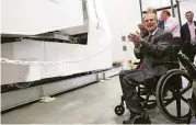  ??  ?? Gov. Greg Abbott gets a demonstrat­ion of the shuttle on Friday in Bryan. Developers hope the system could be operationa­l within three years.