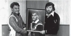  ?? ?? Back in the day - Sir Peter Leitch (right) and Alf Filipaina with a portrait of Olsen in his Kiwi attire.