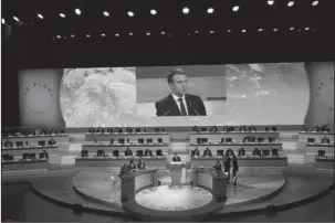  ?? The Associated Press ?? GLOBAL WARMING FIGHT: French President Emmanuel Macron delivers a speech at the One Planet Summit, Tuesday in Boulogne-Billancour­t near Paris, France. More than 50 world leaders are gathering in Paris for a summit that President Emmanuel Macron hopes gives new momentum to the fight against global warming despite U.S. President Donald Trump’s rejection of the Paris climate accord.
