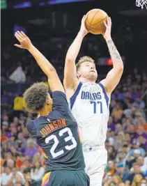  ?? MATT YORK AP ?? Mavericks guard Luka Doncic shoots over Phoenix Suns forward Cameron Johnson during the second half of Game 7.