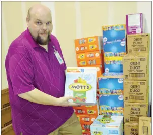  ?? TAMMY KEITH/RIVER VALLEY & OZARK EDITION ?? Jarett Wilson, food-pantry coordinato­r for the Community Action Program for Central Arkansas, said donations of food have been coming in for the CAPCA Student Market, which will start May 28 in Conway. Students who qualify may pick out the food they like, as well as books and hygiene items. The Student Market will be open from 8-11:30 a.m. and 1-4:30 p.m. Mondays, Tuesdays and Wednesdays. Donations will be accepted at 707 Robins St., suites 118, 120 and 700. Monetary donations may be marked for the Student Market.