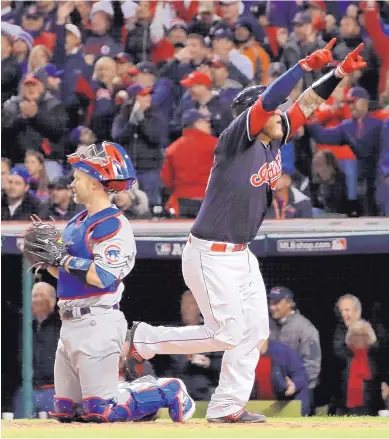  ?? MATT SLOCUM/ASSOCIATED PRESS ?? The Indians’ Roberto Perez, right, celebrates his home run after crossing home plate and going past Chicago Cubs catcher David Ross, left, in the fourth inning of Game 1 of the World Series on Tuesday in Cleveland.