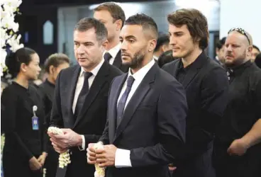  ??  ?? This handout photo taken and released by King Power on November 4 shows Leicester City’s players Danny Simpson (C), Caglar Soyuncu (2nd-R) and other team members paying their respects to Leicester City’s Thai owner and duty-free mogul, Vichai Srivaddhan­aprabha during a funeral ceremony at Wat Thepsirin Buddhist temple in Bangkok. Players and staff from Leicester City will honour Vichai today when the team play Burnley in the Premier League.