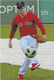  ?? AP PHOTO ?? KICKING IN: Red Sox utility player Brock Holt has some fun with a soccer ball during a workout yesterday at Fenway Park.