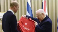  ?? (Mark Neyman/GPO) ?? PRINCE WILLIAM gives President Reuven Rivlin a signed Liverpool FC jersey, at the President’s Residence in Jerusalem yesterday.