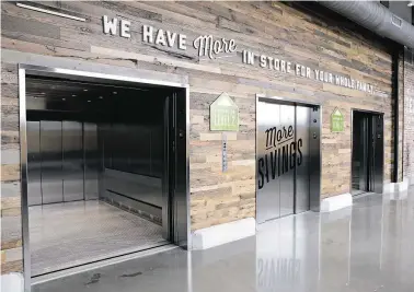  ?? Photos by Michael Wyke / Contributo­r ?? Elevators to the parking levels create an ease of shopping at the Buffalo Heights H-E-B.