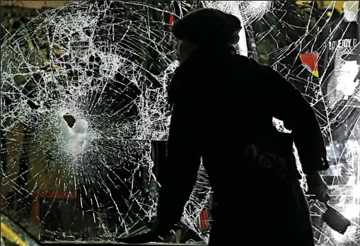  ??  ?? Destructio­n: Dozens of bars and shops were ransacked as hundreds of masked hooligans rioted in Leipzig on Monday