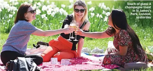  ??  ?? Touch of glass: A champagne toast in St James’s Park, London, yesterday