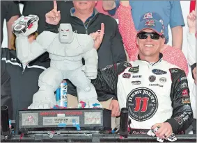  ?? NICK WASS/AP PHOTO ?? Kevin Harvick poses with the trophy in Victory Lane after he won the NASCAR Cup race on Sunday at Dover Internatio­nal Speedway in Dover, Del.