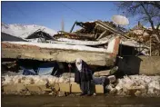  ?? FRANCISCO SECO — THE ASSOCIATED PRESS ?? Turkish Zehra Kurukafa walks past a destroyed house in the village of Polat, Turkey, on Sunday.