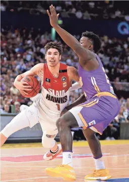  ??  ?? LaMelo Ball of the Illawarra Hawks drives past Jae’Sean Tate of the Sydney Kings during an Australian Basketball League game.