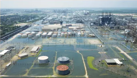  ?? (Adrees Latif/Reuters) ?? FLOODWATER­S caused by Tropical Storm Harvey inundate the Motiva Enterprise­s plant in Port Arthur, Texas, on August 31. Motiva’s 603,000-bpd Port Arthur plant is the largest US refinery and one of six restarting operations.